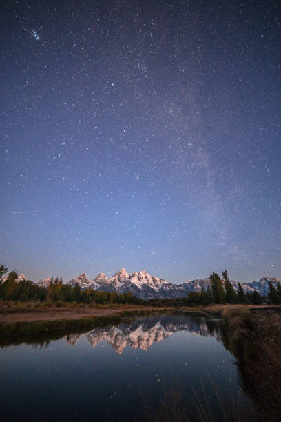 The Grand Tetons Reflecting off the Snake River at night stock photo