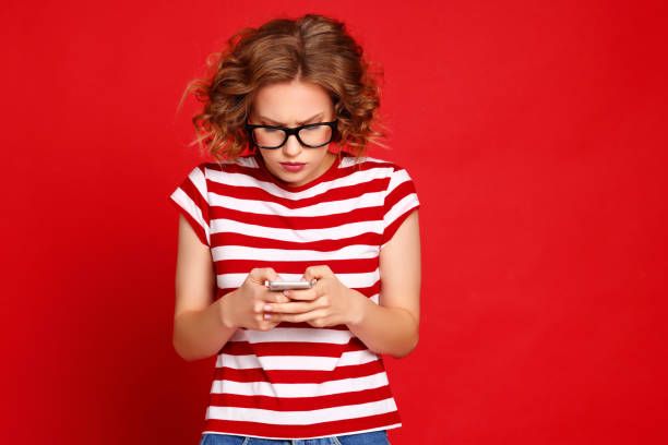istock Surprised woman reading message on smartphone 1302145335