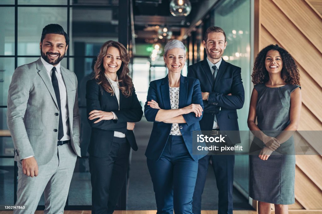 Confidence and success Multi-ethnic group of business persons standing side by side Teamwork Stock Photo