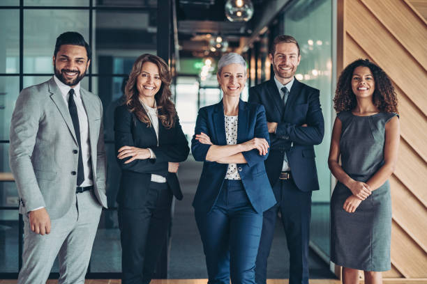 Confidence and success Multi-ethnic group of business persons standing side by side manager stock pictures, royalty-free photos & images