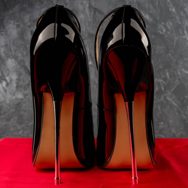 istock Black fetish shiny patent leather stiletto high heels with ankle strap 1302147963