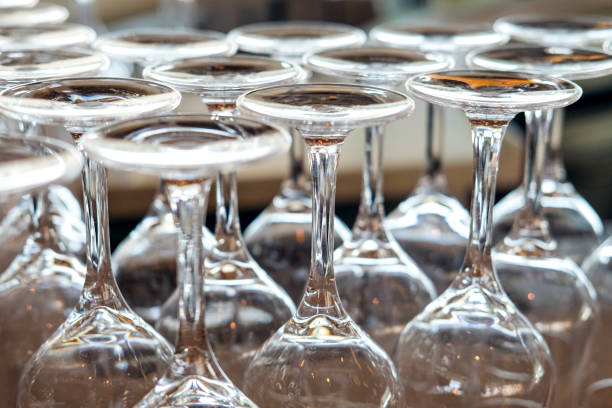 istock Close-up front view of many clean and freshly polished wine glasses upside down ready for use 1302149308