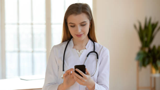 istock Focused young woman physician making call on mobile phone 1302150595