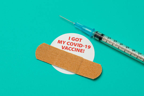Covid-19 coronavirus vaccine sticker with syringe and needle. Concept of vaccination, herd immunity and pandemic healthcare. background, no people covid 19 vaccine photos stock pictures, royalty-free photos & images