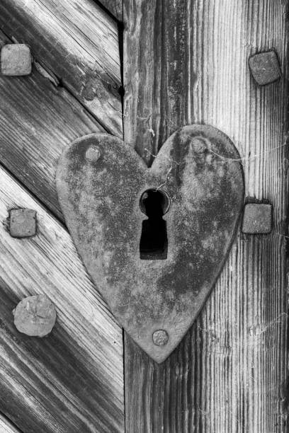 Heart shaped lock on wooden door.