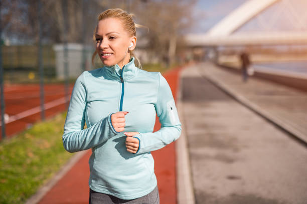 istock Mid adult woman running. 1302151038