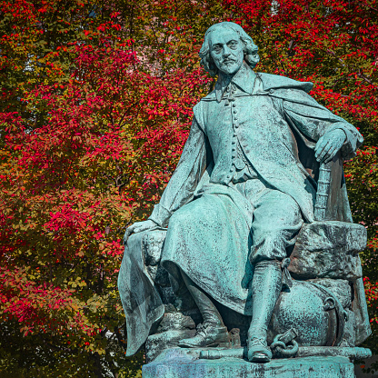 Statue of great scientist Otto von Guericke in red and golden Autumn colors in historical downtown of Magdeburg Germany, at sunny day, closeup, details