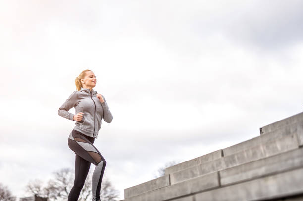istock Young woman running outdoors. 1302151748