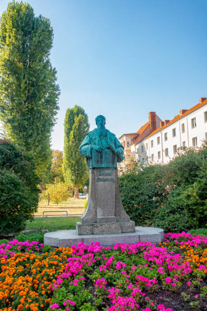 istock Monument for Johann Gutenberg, German inventor who developed mechanical type printing press to print books in historical and shopping downtown in Magdeburg, Germany, early Autumn. 1302151752