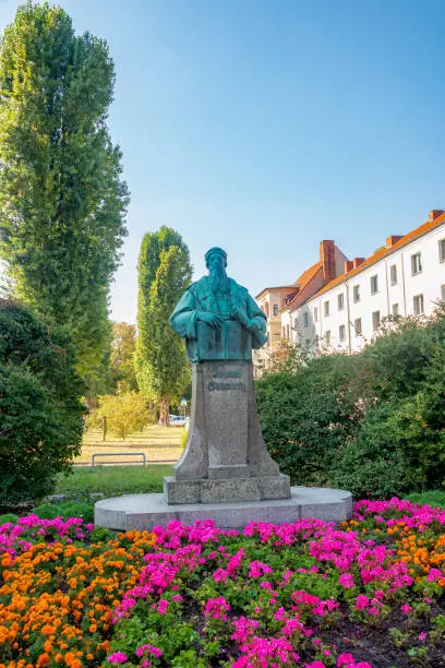 Photo of Monument for Johann Gutenberg, German inventor who developed mechanical type printing press to print books in historical and shopping downtown in Magdeburg, Germany, early Autumn.