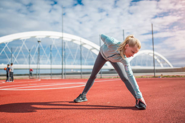 istock Young woman stretching outdoors. 1302151772