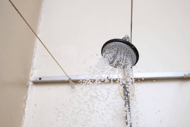 istock Water flowing from an old shower head with ceramic handle with limescale needed to be replaced or decalcified 1302152237