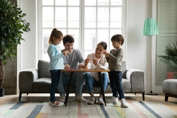 istock Smiling young affectionate parents making bracelets with small children. 1302153194