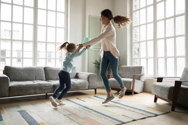 istock Overjoyed little kid girl having fun dancing with mum. 1302153196