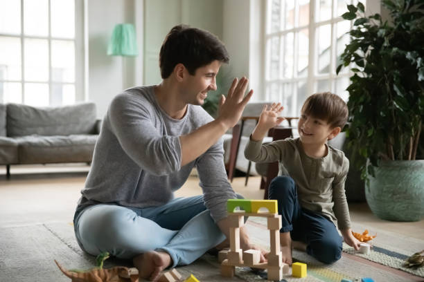 istock Happy young daddy giving high five to joyful small son. 1302153208