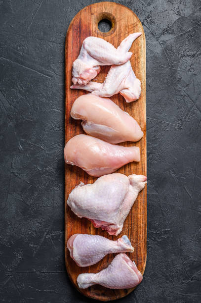 istock Different types of raw chicken meat, poultry. Black background. Top view 1302153559
