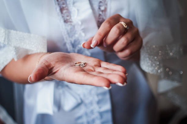 istock the bride holds a gold ring in her hands 1302154749
