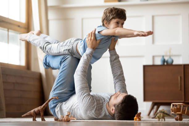 istock Happy father play with excited little son 1302155991