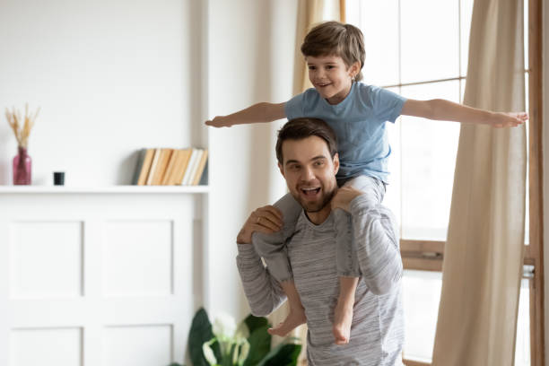 istock Happy young dad and little son play at home 1302156025
