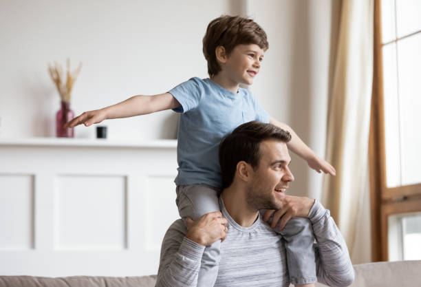 istock Happy father have fun at home with little son 1302156031