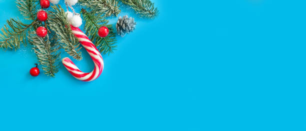 istock Christmas tree branch, candies on a colored background 1302158201