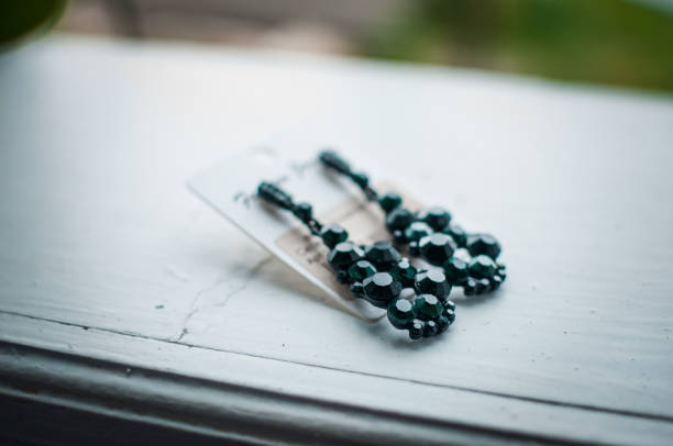 istock earrings with green stones on a white background 1302162520