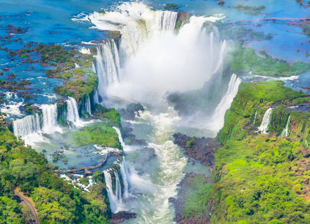 Beautiful aerial view of Iguazu Falls, one of the most beautiful places in the world - Foz do Iguacu Declared a world heritage in 1984, this marvel of nature with 275 waterfalls formed by the Iguazu River between Brazil and Argentina represents the largest set of waterfalls in the world. Its biggest drop known as the Devil's Throat, reaches approximately 150 meters wide and 80 meters high. devils throat stock pictures, royalty-free photos & images