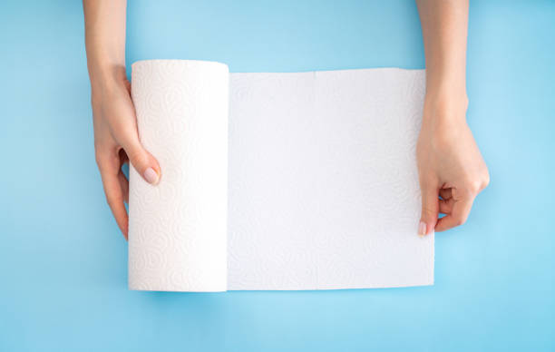 Hand holding white paper towel stock photo