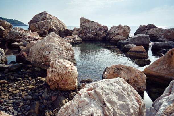 Rocky Mediterranean sea coast. Big stones and pebbles