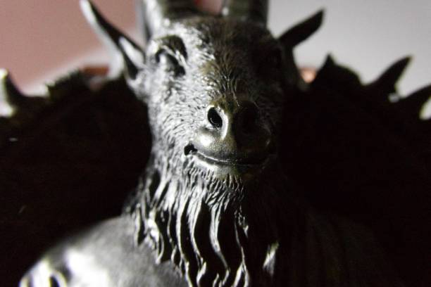 Black Lucifer Figure A low angle shot of a black pan lucifer figure. satan goat stock pictures, royalty-free photos & images