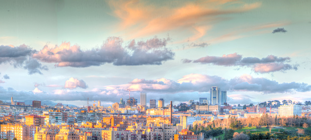 Madrid skyline at sunset with snowy mountains in the background