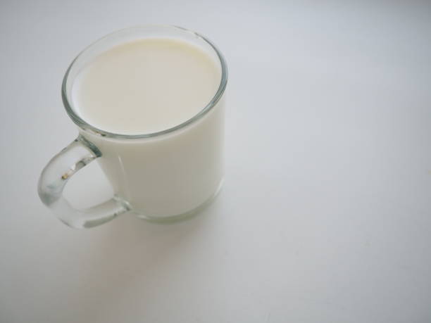 istock Glass cup with milk on a white background. Diet protein food 1302172671