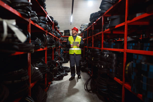 istock Young male engineer doing stock control by using a digital tablet in a warehouse 1302174979