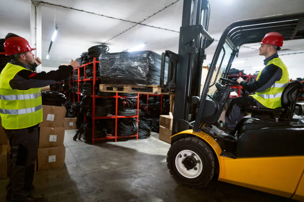 istock Male driver operating forklift while his colleague giving him instructions. 1302175037