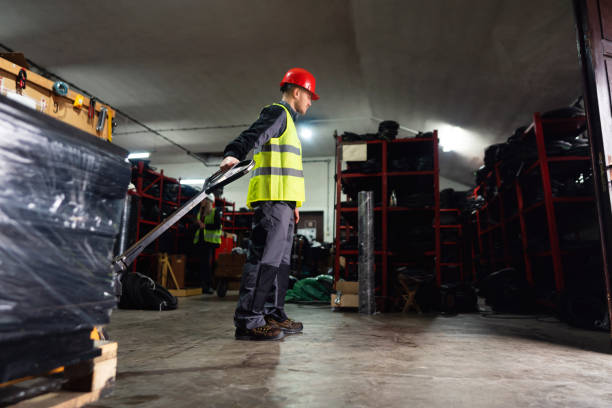 istock One male worker with hand pallet jack unloading pallet goods in a warehouse 1302175046