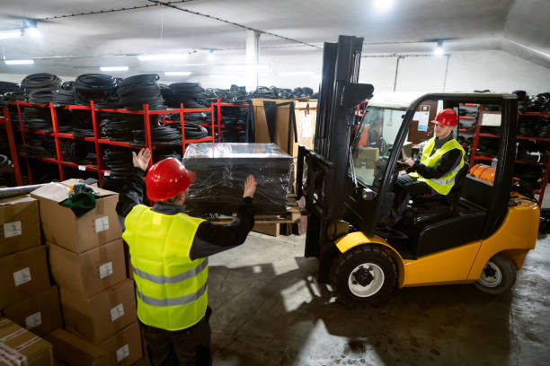 istock One male driver operating forklift while his colleague giving him instructions. 1302175050