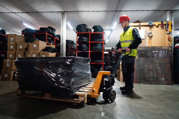 istock One male worker with hand pallet jack unloading pallet goods in a warehouse 1302175061