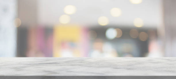 istock marble table top with blurred abstract cafe restaurant interior background 1302175077