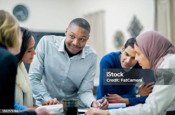 Working Together On A Business Plan Stock Photo - Download Image Now - Emigration and Immigration, Multiracial Group, Teamwork