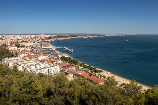 View of Setúbal bay and the city, in Portugal, from the São Filipe fort on a summer day. The city of Setúbal is located on the north bank of the mouth of the river Sado, forming a bay. With access to the Atlantic Ocean, Setúbal is also important as a fishing port in addition to its industrial port. setúbal city portugal stock pictures, royalty-free photos & images