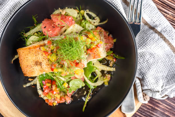 Grilled barramundi with fennel, pink grapefruit stock photo