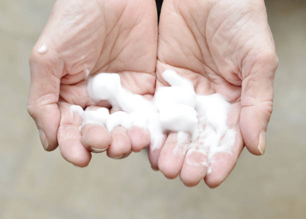 istock Senior Woman Using Foaming Hand Sanitizer 1302188811