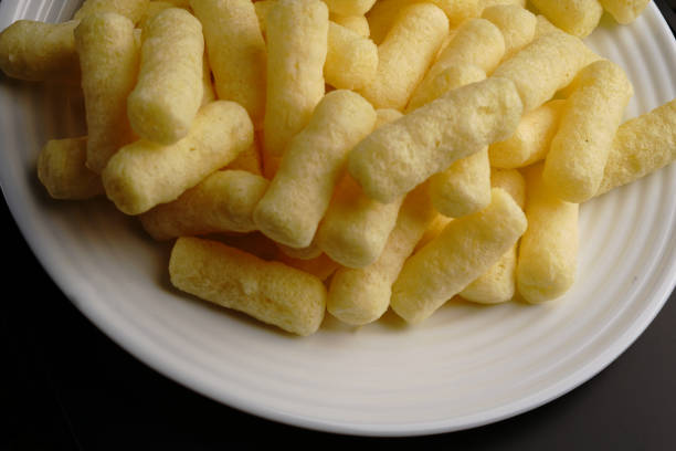 istock Corn sweet sticks on a white plate top view. Golden color. 1302190438