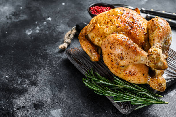 Grilled roasted whole Chicken.  Black background. Top view. Copy space Grilled roasted whole Chicken.  Black background. Top view. Copy space. celebrity roast stock pictures, royalty-free photos & images