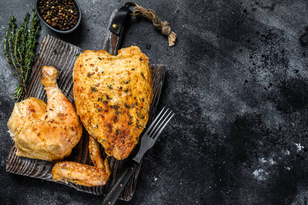 Butchered  grilled whole chicken.  Black background. Top view. Copy space Butchered  grilled whole chicken.  Black background. Top view. Copy space. chicken breast photos stock pictures, royalty-free photos & images