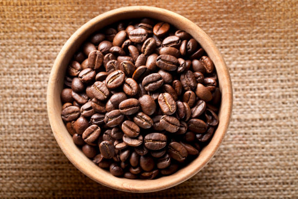istock Coffee beans in wooden bowl 1302205637
