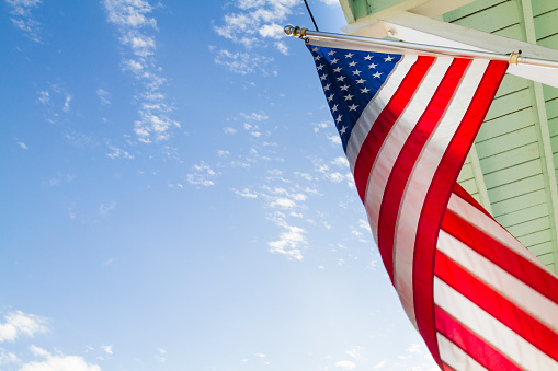 Proudly front balcony displaying an American Flag at Key West's downtown, Florida, USA on a sunny winter day.