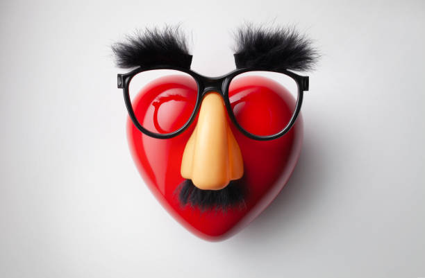 Funny heart Red heart with funny glasses on a white background. groucho marx disguise stock pictures, royalty-free photos & images