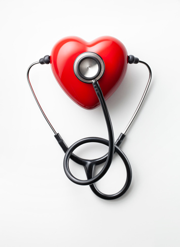 Red heart with stethoscope isolated on a white background.