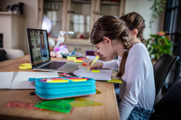 istock Girls attending online school class 1302209538